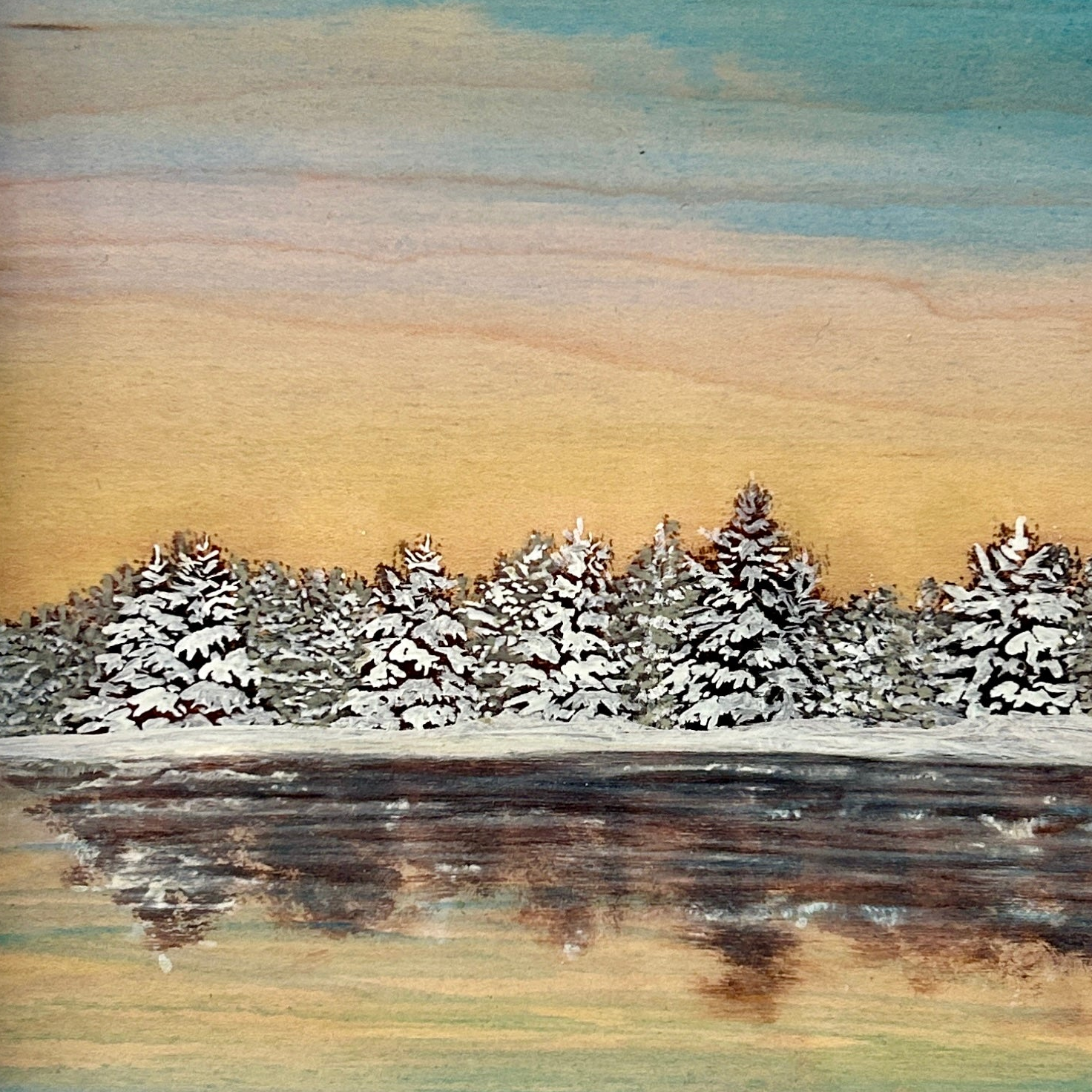 Winter landscape with snow-covered trees and a sunset sky.